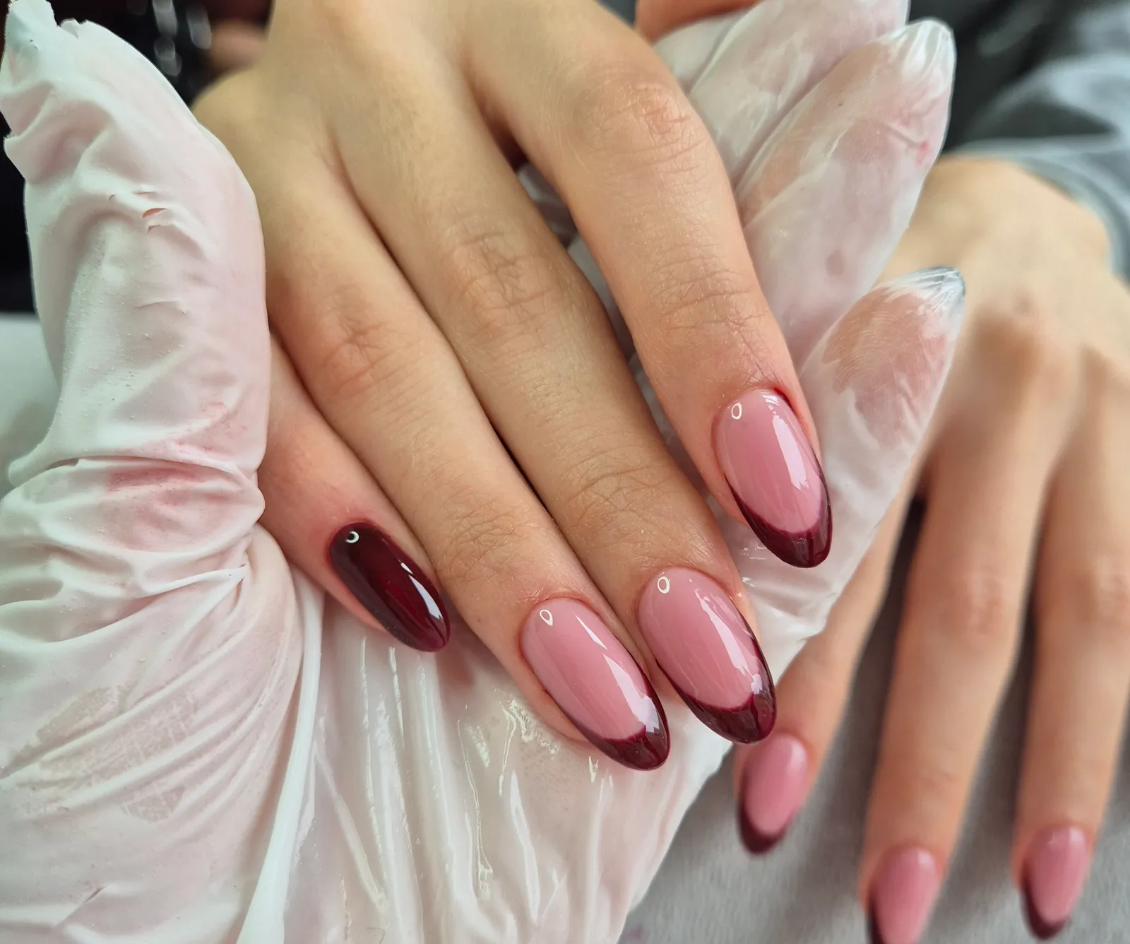 Pink almond nails with deep cherry French tips